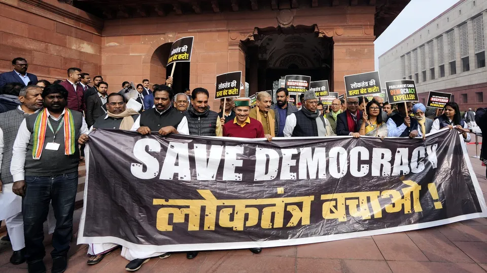 Leader of Opposition in the Rajya Sabha Mallikarjun Kharge with suspended opposition MPs during a protest over their suspension at Mahatma Gandhi statue