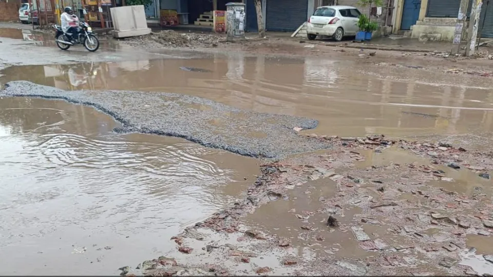 waterlogging and potholes on road in Mundka