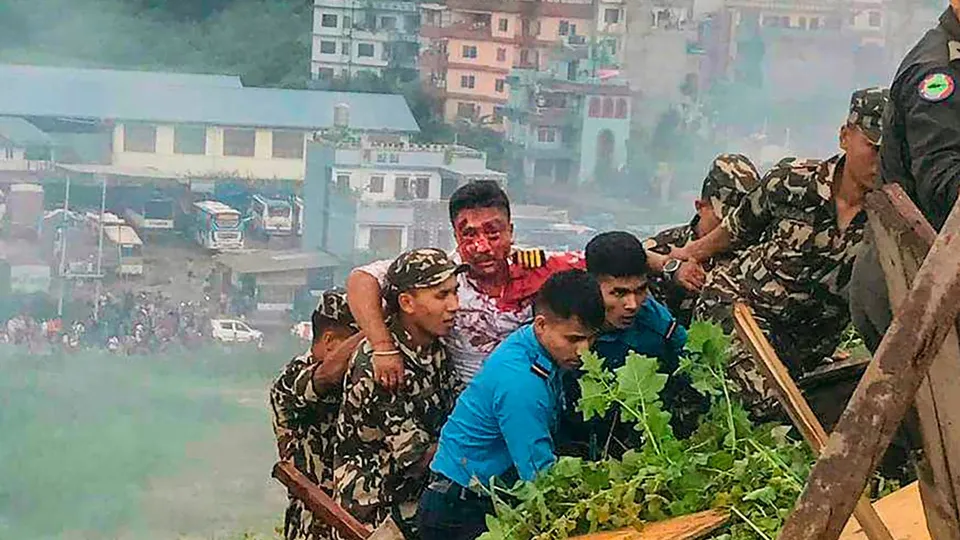 The injured pilot of the Saurya Airlines being rescued after the Pokhara bound aircraft crashed during takeoff at the Tribhuvan International Airport (TIA), in Kathmandu, Wednesday, July 24, 2024.