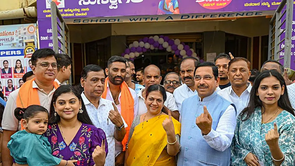 Union Minister and BJP leader Pralhad Joshi accompanied by his family members shows inked fingers after casting votes at a polling during the 3rd phase of Lok Sabha polls, in Hubballi, Tuesday, May 7, 2024