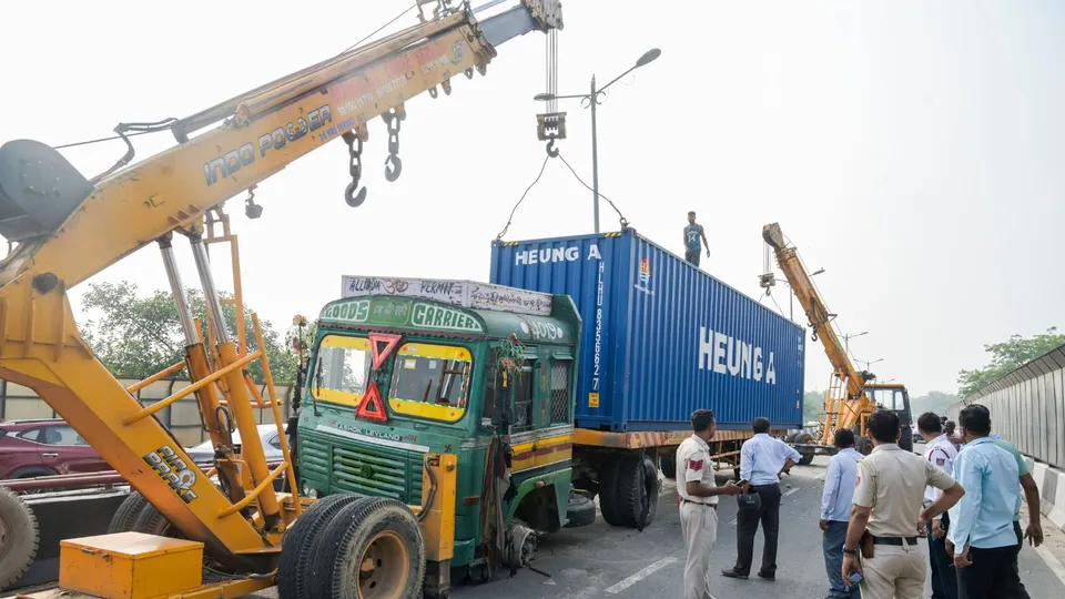 A truck being removed from Munirka Flyover using a crane after its collision with another truck, in New Delhi, Tuesday, July 16, 2024.