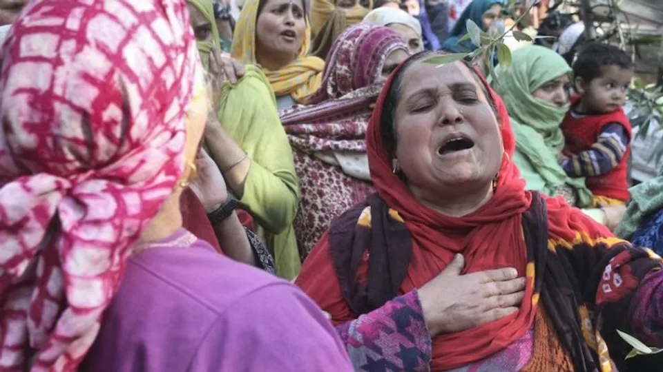 Women mourn after Puran Krishan Bhat, a Kashmiri Pandit, was killed by terrorists in Shopian on Saturday